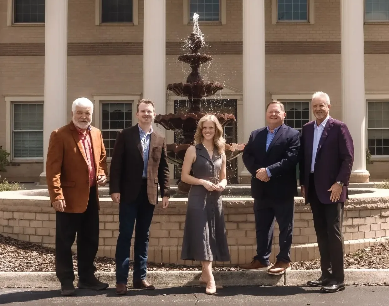 The Price Richards team together in front of a fountain